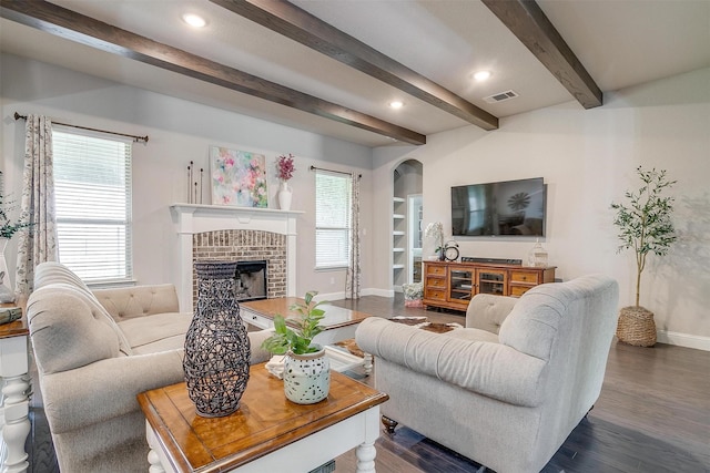 404 Bluffside Trl, Benbrook, TX 76126 - living area with a brick fireplace, beamed ceiling, dark wood-style flooring, arched walkways, and recessed lighting