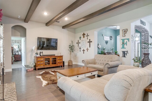404 Bluffside Trl, Benbrook, TX 76126 - living area featuring arched walkways, wood finished floors, beamed ceiling, and recessed lighting
