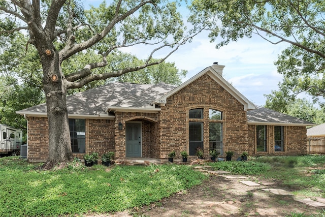 3801 Woodside Dr, Arlington, TX 76016 - view of front facade with brick siding, a chimney, a shingled roof, and a front lawn