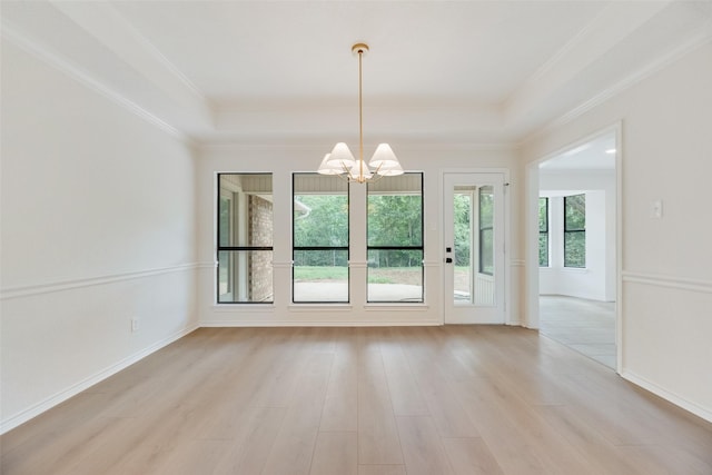 3801 Woodside Dr, Arlington, TX 76016 - unfurnished dining area with a chandelier, light wood-style flooring, a tray ceiling, and crown molding