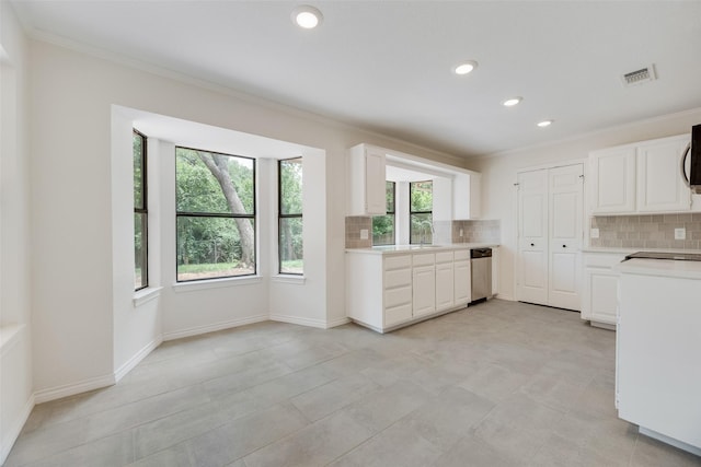 3801 Woodside Dr, Arlington, TX 76016 - kitchen with ornamental molding, backsplash, light countertops, dishwasher, and white cabinets