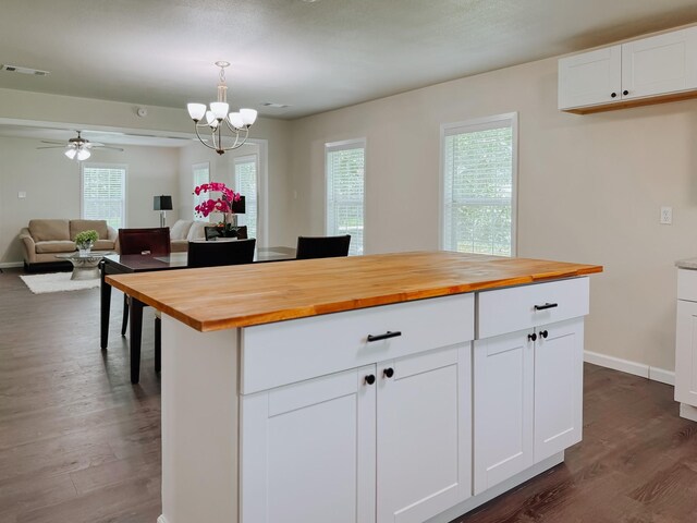 1605 N Beaton St, Corsicana, TX 75110 - kitchen with wooden counters, dark wood-style floors, a chandelier, open floor plan, and white cabinets