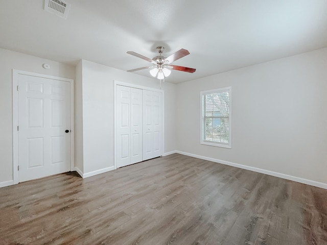 1605 N Beaton St, Corsicana, TX 75110 - unfurnished bedroom featuring wood finished floors, a closet, and ceiling fan