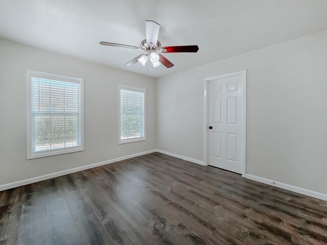 1605 N Beaton St, Corsicana, TX 75110 - unfurnished room with dark wood finished floors and a ceiling fan