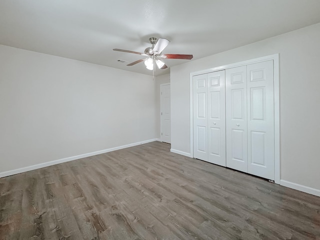 1605 N Beaton St, Corsicana, TX 75110 - unfurnished bedroom with wood finished floors, a closet, and ceiling fan