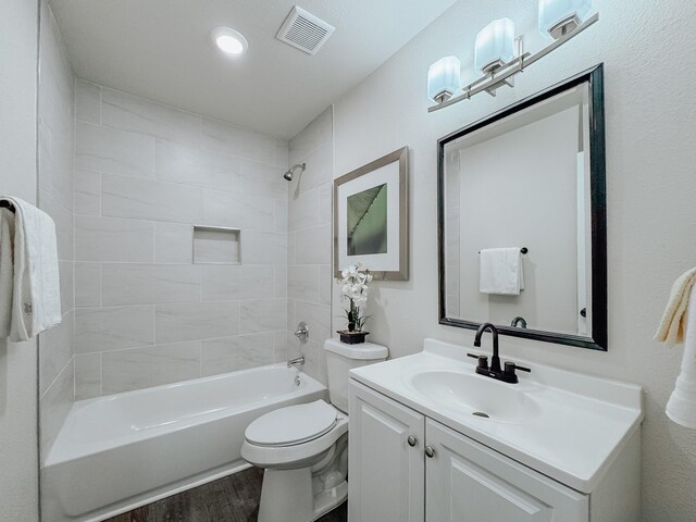 1605 N Beaton St, Corsicana, TX 75110 - full bath featuring vanity,  shower combination, and wood finished floors