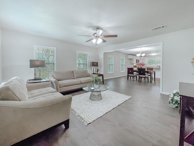 1605 N Beaton St, Corsicana, TX 75110 - living room with a chandelier, wood finished floors, and ceiling fan