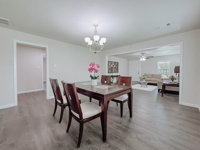 1605 N Beaton St, Corsicana, TX 75110 - dining area featuring wood finished floors, a chandelier, and a ceiling fan