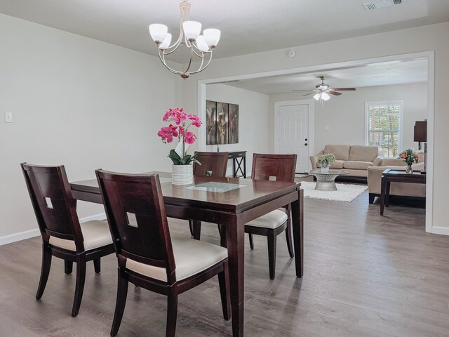 1605 N Beaton St, Corsicana, TX 75110 - dining space featuring wood finished floors, a ceiling fan, and a chandelier