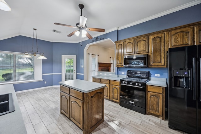 700 Lake Vista Ln, Lavon, TX 75166 - kitchen with black appliances, light countertops, a kitchen island, a ceiling fan, and wood tiled floors