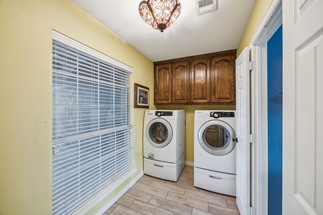 700 Lake Vista Ln, Lavon, TX 75166 - washroom featuring washer and dryer, cabinet space, and wood finish floors