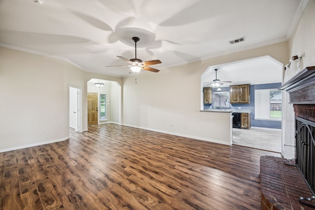 700 Lake Vista Ln, Lavon, TX 75166 - unfurnished living room with a ceiling fan, wood finished floors, a fireplace, and crown molding