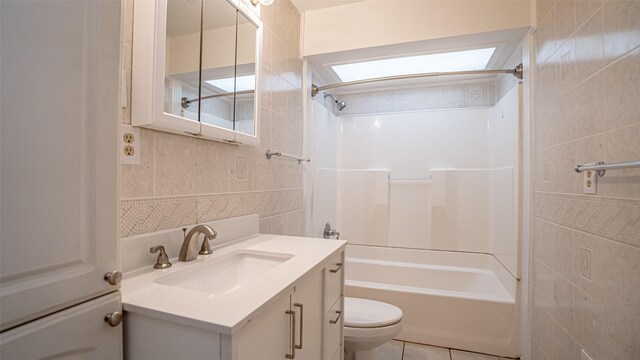 217 Wintercrest Rd, Burleson, TX 76028 - bathroom featuring tile walls, shower / tub combination, vanity, and tile patterned flooring