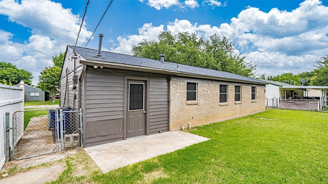 217 Wintercrest Rd, Burleson, TX 76028 - back of property with a gate, brick siding, and a patio