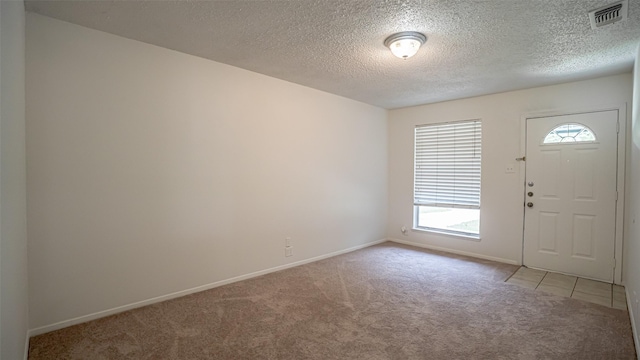 217 Wintercrest Rd, Burleson, TX 76028 - entrance foyer featuring light colored carpet and a textured ceiling