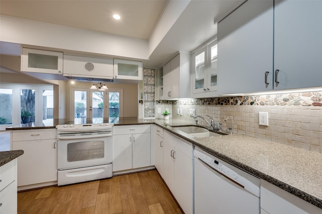 1810 Socorro Ln, Irving, TX 75061 - kitchen featuring white appliances, a peninsula, white cabinets, dark stone countertops, and tasteful backsplash
