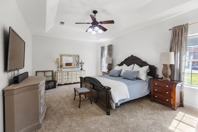 2110 Park Rdg, Denison, TX 75020 - bedroom featuring a tray ceiling, light carpet, and a ceiling fan