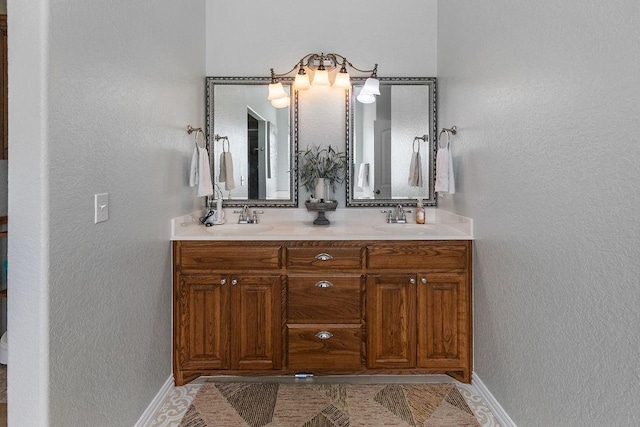 2110 Park Rdg, Denison, TX 75020 - bathroom featuring double vanity and a textured wall