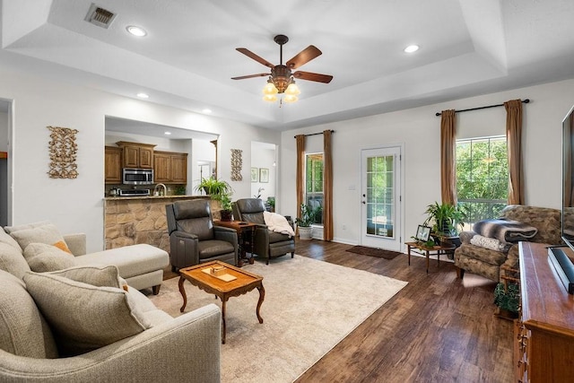 2110 Park Rdg, Denison, TX 75020 - living area featuring a tray ceiling, dark wood-type flooring, ceiling fan, and recessed lighting