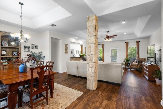 2110 Park Rdg, Denison, TX 75020 - dining area featuring a raised ceiling, dark wood finished floors, decorative columns, a chandelier, and ceiling fan