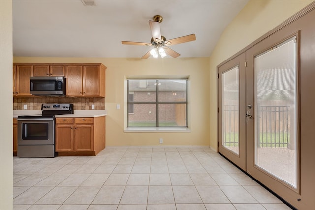 4305 Sonoma Dr, Denton, TX 76226 - kitchen with appliances with stainless steel finishes, french doors, backsplash, and brown cabinetry