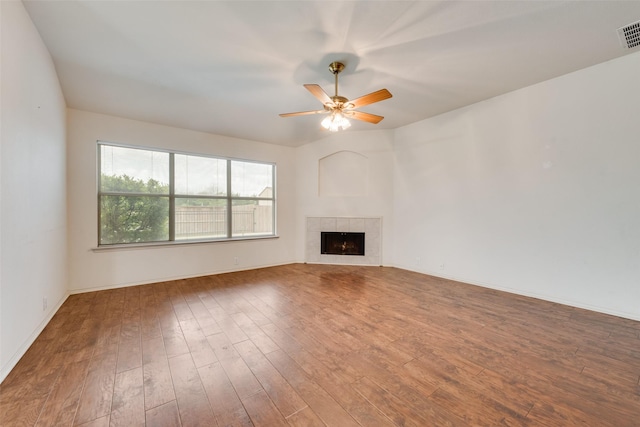 4305 Sonoma Dr, Denton, TX 76226 - unfurnished living room with wood finished floors, a ceiling fan, and a tiled fireplace