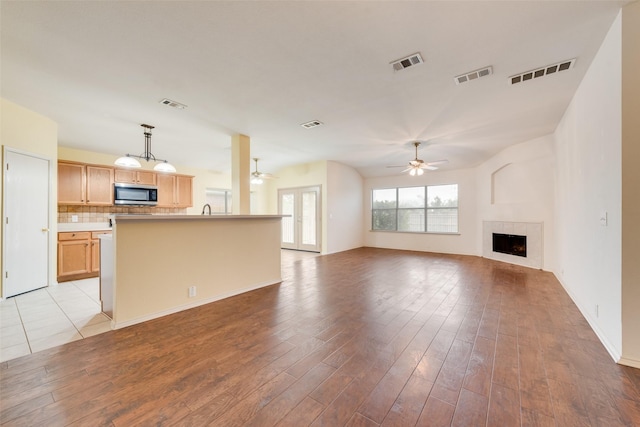 4305 Sonoma Dr, Denton, TX 76226 - unfurnished living room with a ceiling fan, light wood-type flooring, and a fireplace