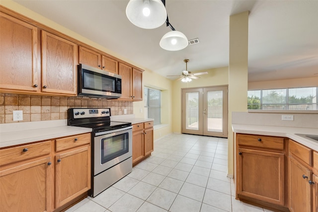 4305 Sonoma Dr, Denton, TX 76226 - kitchen featuring stainless steel appliances, light tile patterned floors, french doors, decorative backsplash, and light countertops