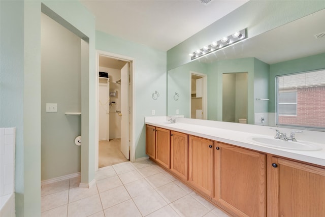 4305 Sonoma Dr, Denton, TX 76226 - bathroom featuring double vanity, a walk in closet, and tile patterned flooring
