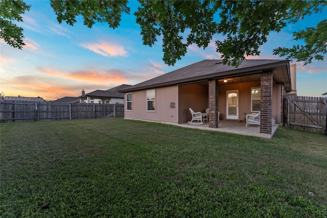 6625 Vista View Dr, Woodway, TX 76712 - back of property at dusk with a fenced backyard and a patio