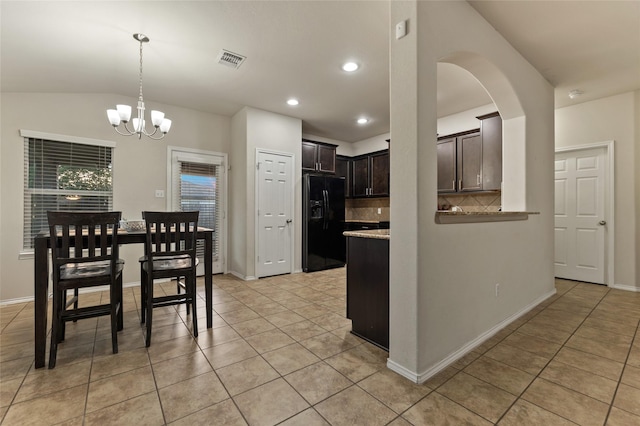 6625 Vista View Dr, Woodway, TX 76712 - kitchen with black fridge with ice dispenser, decorative backsplash, light tile patterned flooring, dark brown cabinets, and recessed lighting