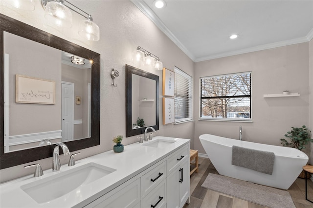 111 Hickory Creek Cir, Gun Barrel City, TX 75156 - bathroom with crown molding, double vanity, a freestanding bath, wood finished floors, and recessed lighting