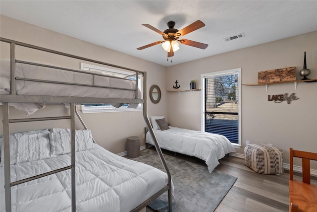 111 Hickory Creek Cir, Gun Barrel City, TX 75156 - bedroom with multiple windows, wood finished floors, and a ceiling fan
