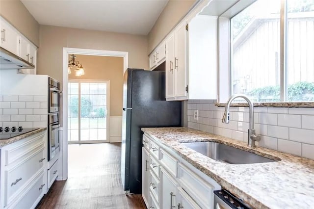 403 Gingerbread Ln, Waxahachie, TX 75165 - kitchen featuring black appliances, white cabinets, and tasteful backsplash