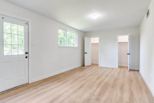 118 W Wanda Dr, Garland, TX 75040 - unfurnished bedroom featuring light wood-style flooring and two closets