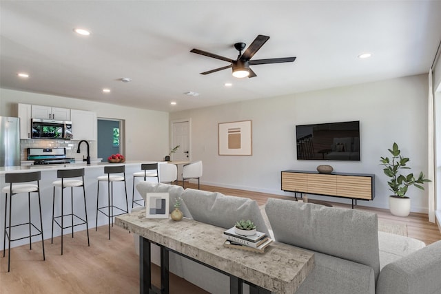 118 W Wanda Dr, Garland, TX 75040 - living room with ceiling fan, light wood-style floors, and recessed lighting