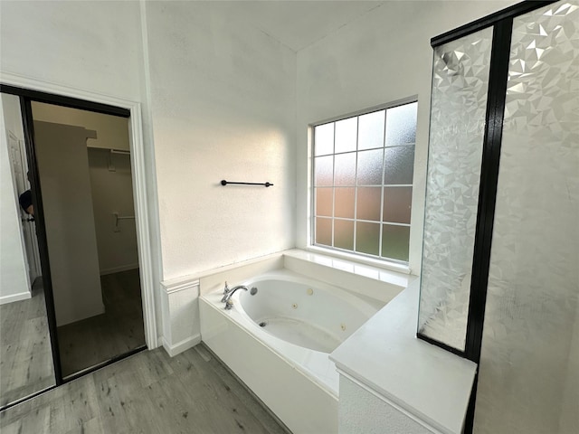 4201 Iron Ln, Mansfield, TX 76063 - bathroom featuring a whirlpool tub, wood finished floors, and a spacious closet