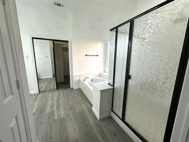 4201 Iron Ln, Mansfield, TX 76063 - bathroom with wood finished floors, a bath, and a stall shower