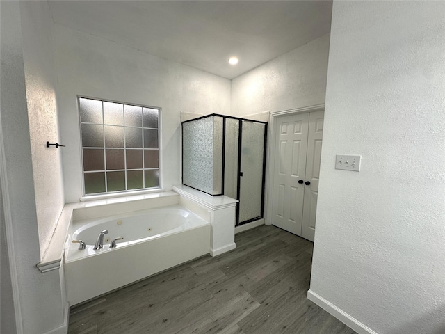 4201 Iron Ln, Mansfield, TX 76063 - bathroom with wood finished floors, a stall shower, a textured wall, and a whirlpool tub