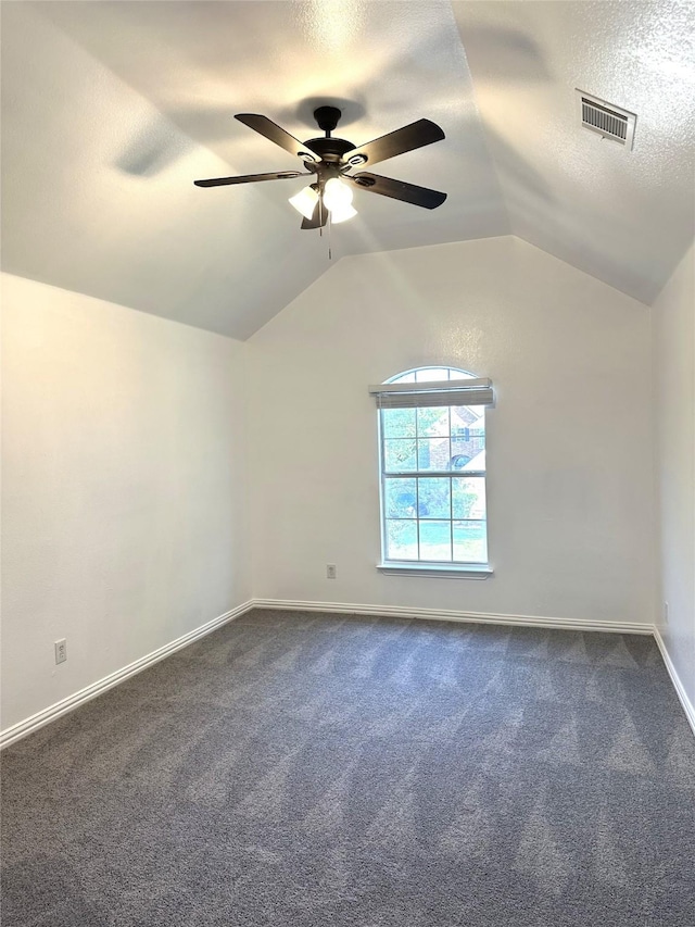 4201 Iron Ln, Mansfield, TX 76063 - empty room featuring vaulted ceiling, dark carpet, ceiling fan, and a textured ceiling
