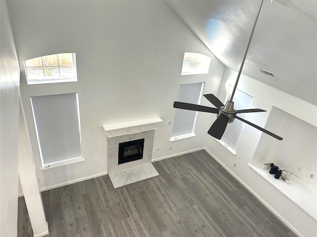 4201 Iron Ln, Mansfield, TX 76063 - unfurnished living room featuring wood finished floors, lofted ceiling, a ceiling fan, and a fireplace