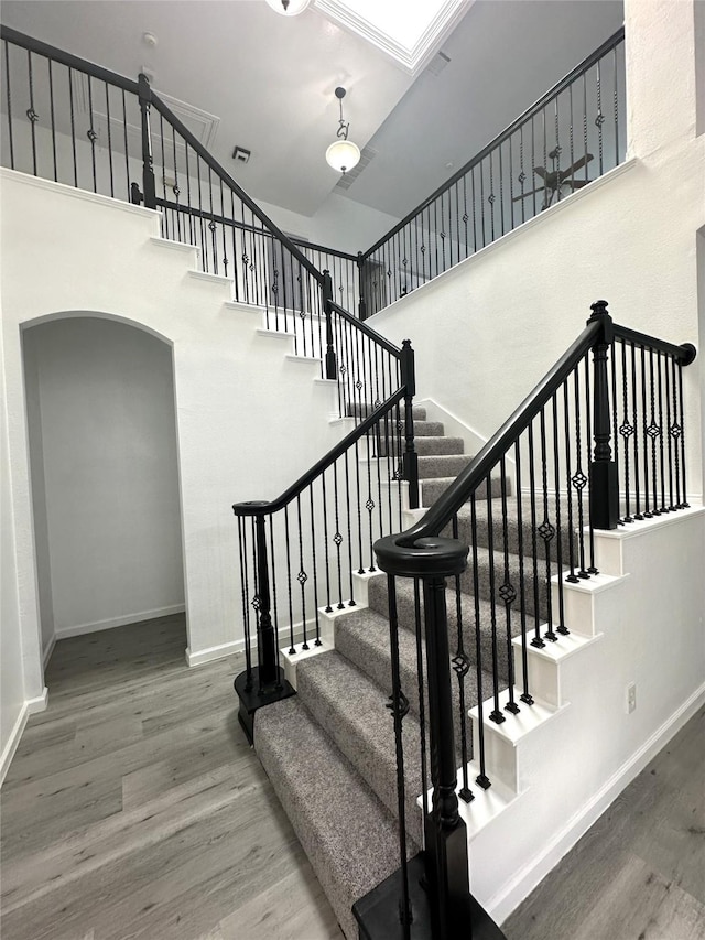 4201 Iron Ln, Mansfield, TX 76063 - stairs featuring a towering ceiling, wood finished floors, and arched walkways
