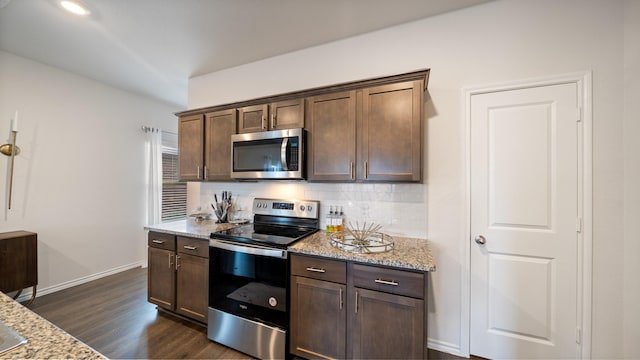 2026 Ocelot St, Crandall, TX 75114 - kitchen with stainless steel appliances, light stone counters, backsplash, dark wood-style flooring, and dark brown cabinetry