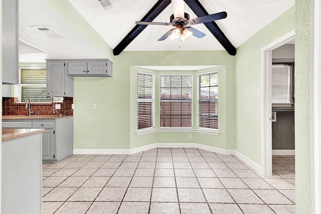 4005 Azalea Ln, Garland, TX 75043 - kitchen featuring light tile patterned floors, a ceiling fan, decorative backsplash, light countertops, and gray cabinets