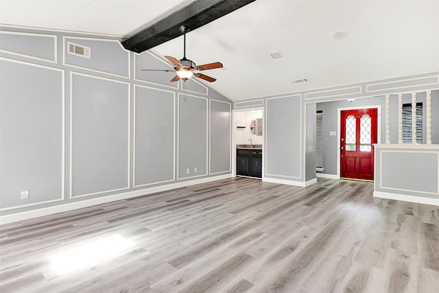 4005 Azalea Ln, Garland, TX 75043 - unfurnished living room with a decorative wall, a ceiling fan, and light wood finished floors
