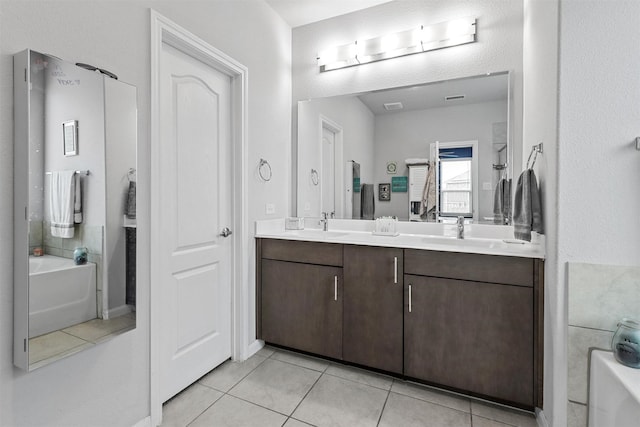 1154 Holcombe Dr, Anna, TX 75409 - full bath featuring a tub to relax in, double vanity, and tile patterned floors