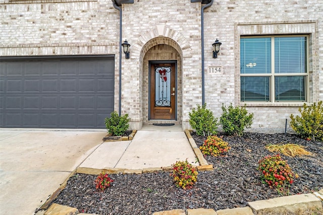 1154 Holcombe Dr, Anna, TX 75409 - entrance to property featuring concrete driveway, brick siding, and an attached garage