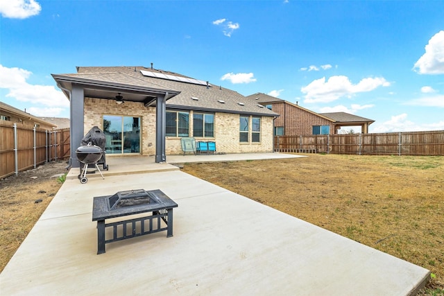 1154 Holcombe Dr, Anna, TX 75409 - rear view of property featuring a fire pit, a patio, brick siding, a fenced backyard, and a shingled roof
