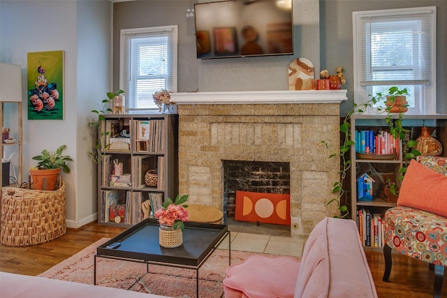 1211 Lansford Ave, Dallas, TX 75224 - living room with wood finished floors and a brick fireplace