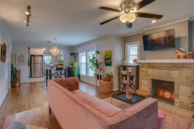 1211 Lansford Ave, Dallas, TX 75224 - living area with healthy amount of natural light, a ceiling fan, crown molding, light wood finished floors, and a fireplace with flush hearth
